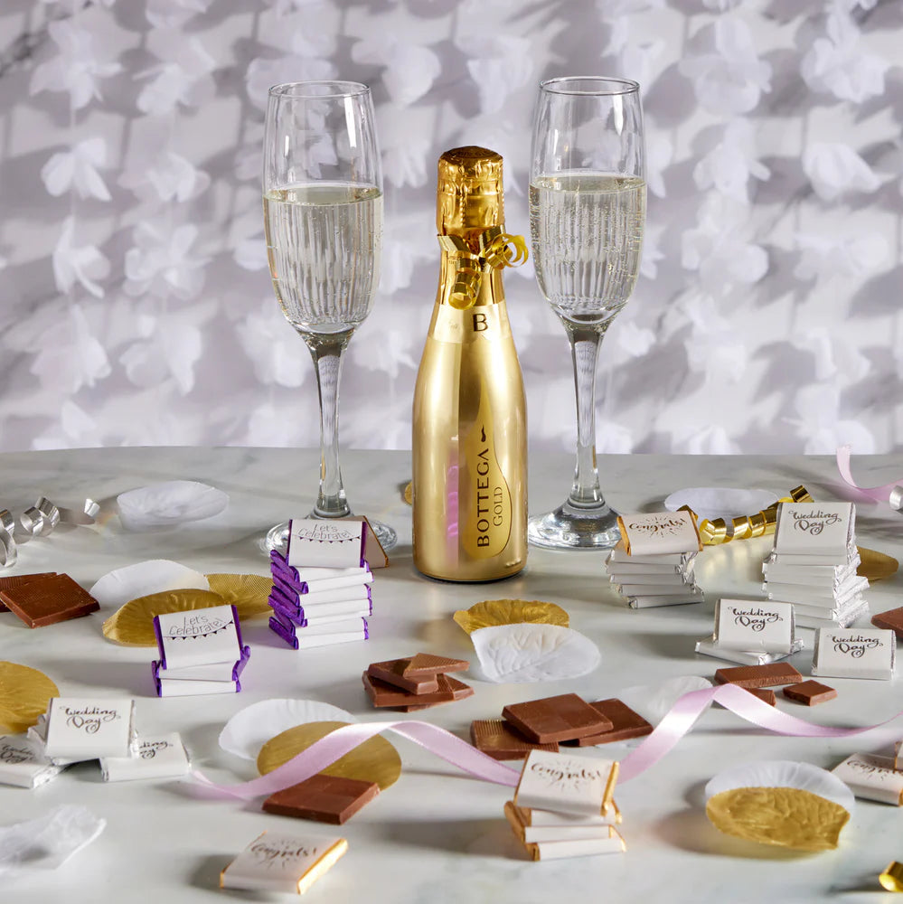 White wrapper with shimmering gold “Congrats” design