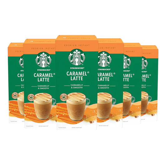 A freshly made Starbucks Caramel Latte from an instant sachet, topped with rich, creamy foam in a white mug
