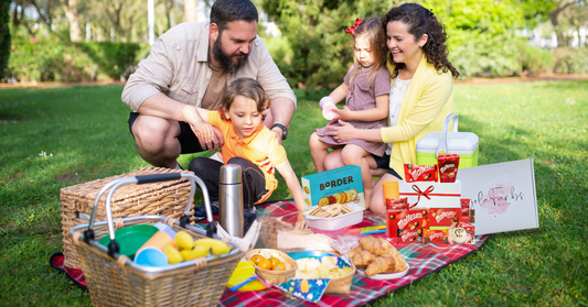 Colourful summer snacks and party treats arranged in a picnic-style flat lay, perfect for birthdays, events, and seasonal gifting