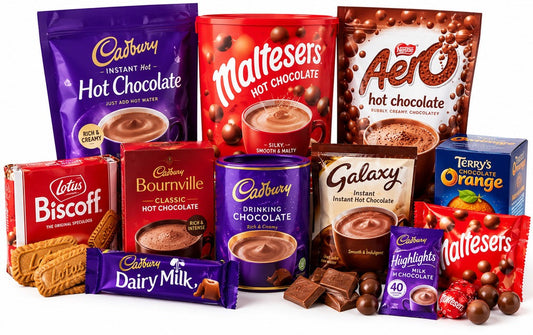 Illustrative studio arrangement of hot chocolate products and chocolate treats on a plain white background
