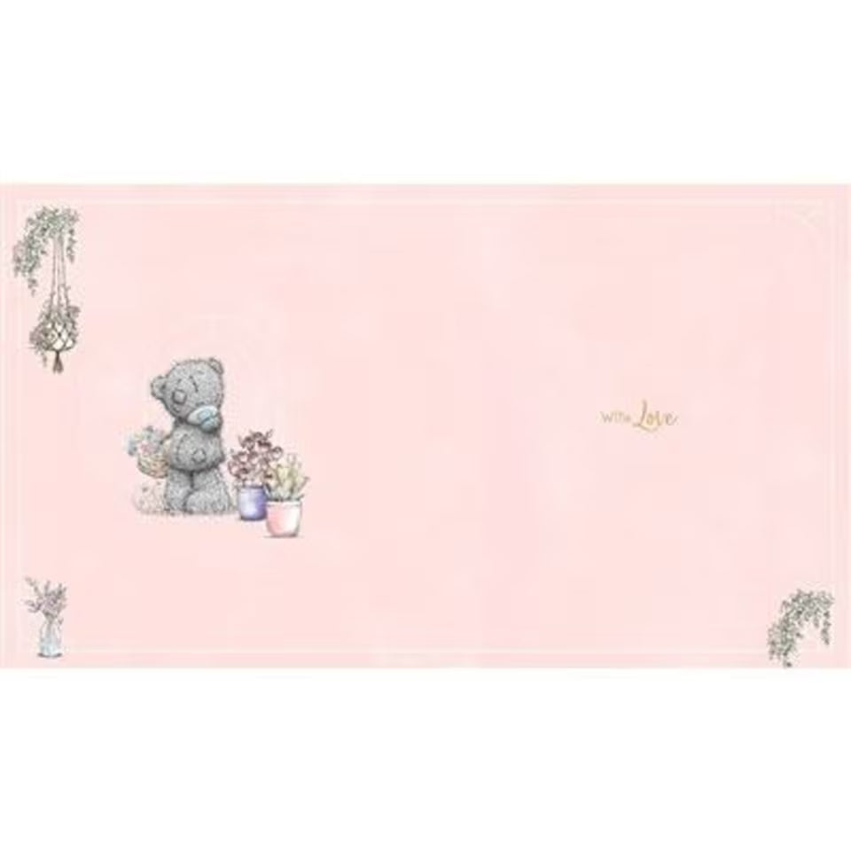 Adorable bear holding a vase of flowers design