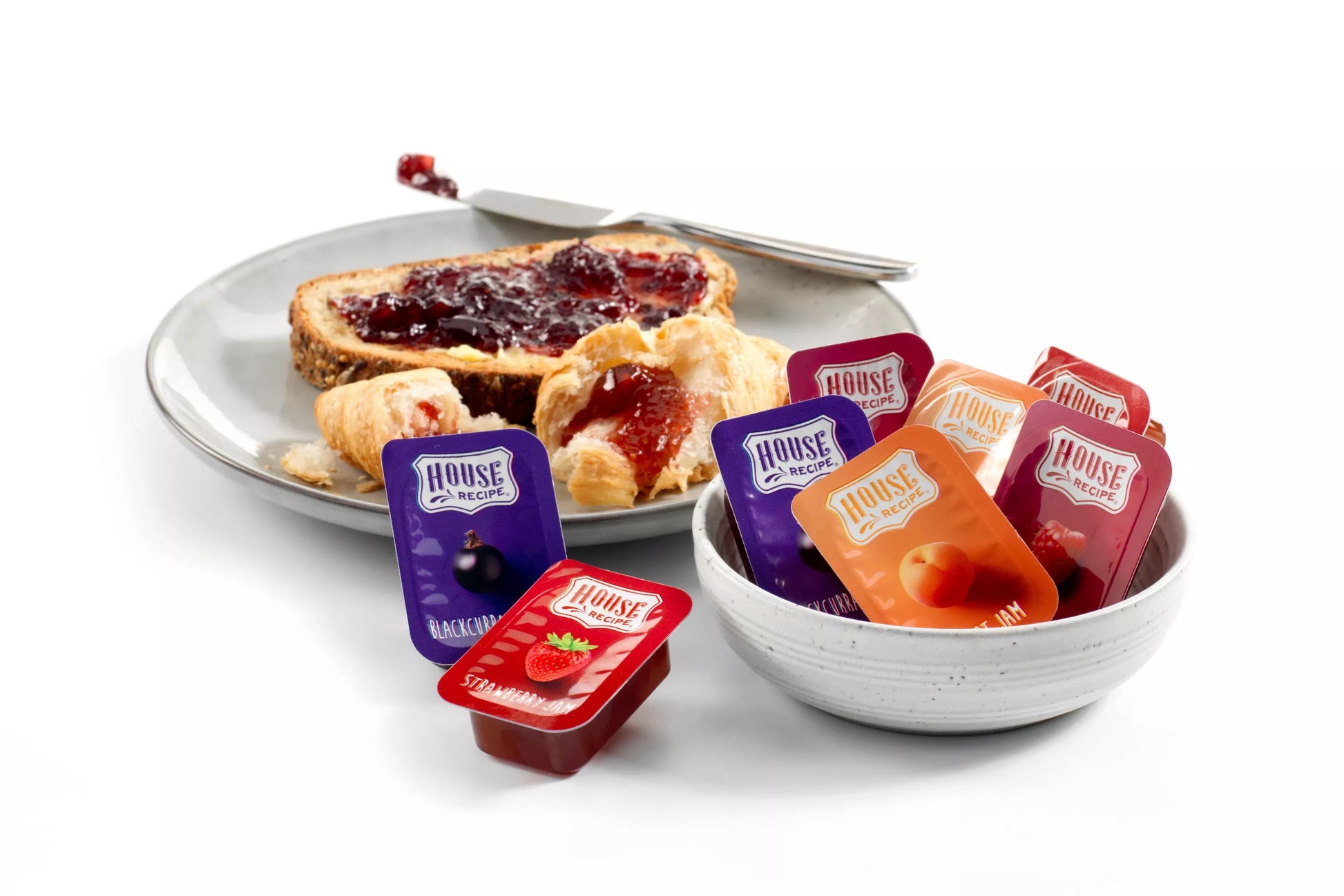 Assorted apricot blackcurrant raspberry and strawberry jam servings