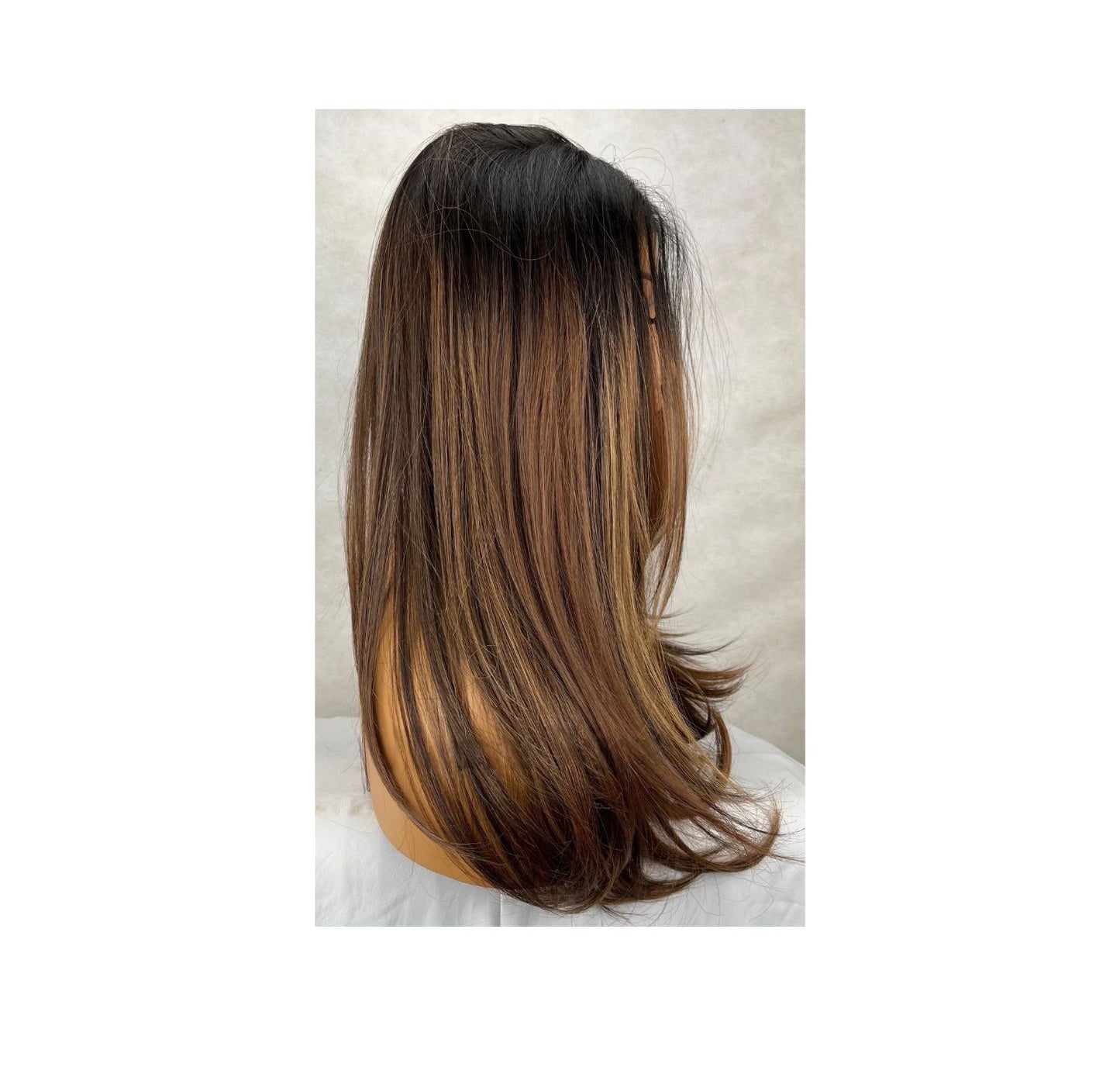 Long straight hairstyle with soft highlights and lowlights
