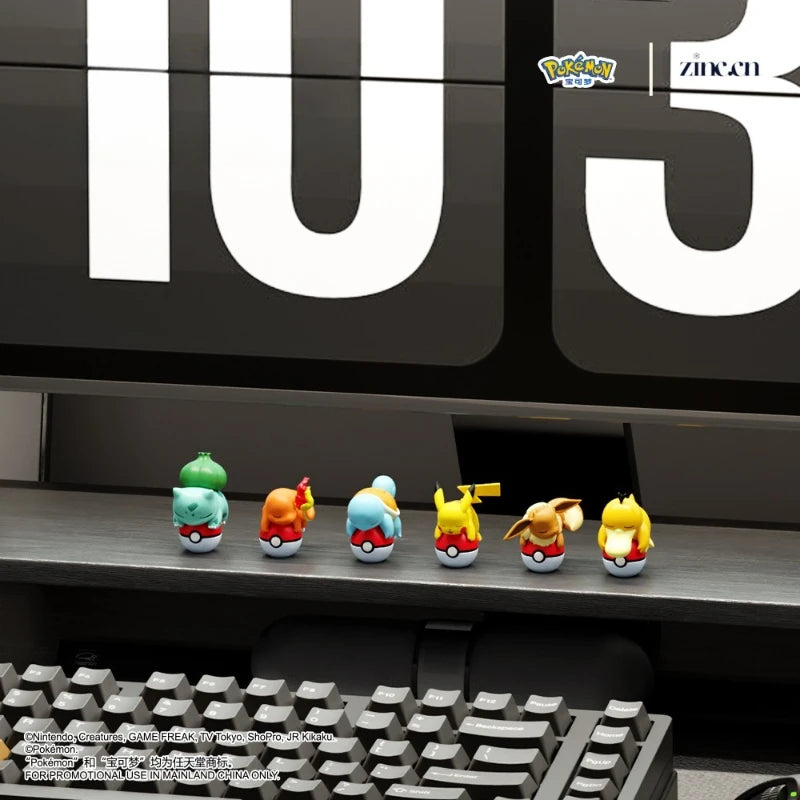 Pokémon figurines on a desk with a computer monitor displaying '105'.