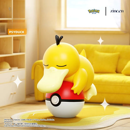 Toy figure of a yellow bird-like creature with a red shirt in a room with a yellow couch and shelves.