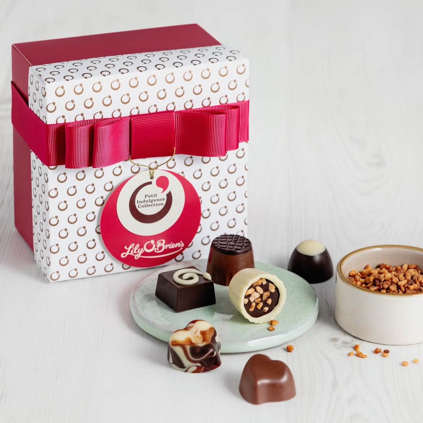 Gourmet miniature chocolates featuring Sticky Toffee, Praline Perfection, and Raspberry Cream