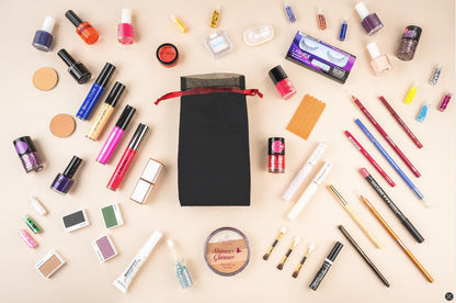 Organza black pouch filled with makeup and nail essentials