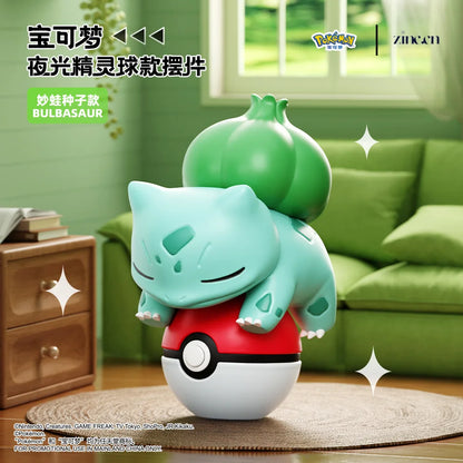 Toy figure of Bulbasaur from Pokémon in a living room setting with green sofa and window.