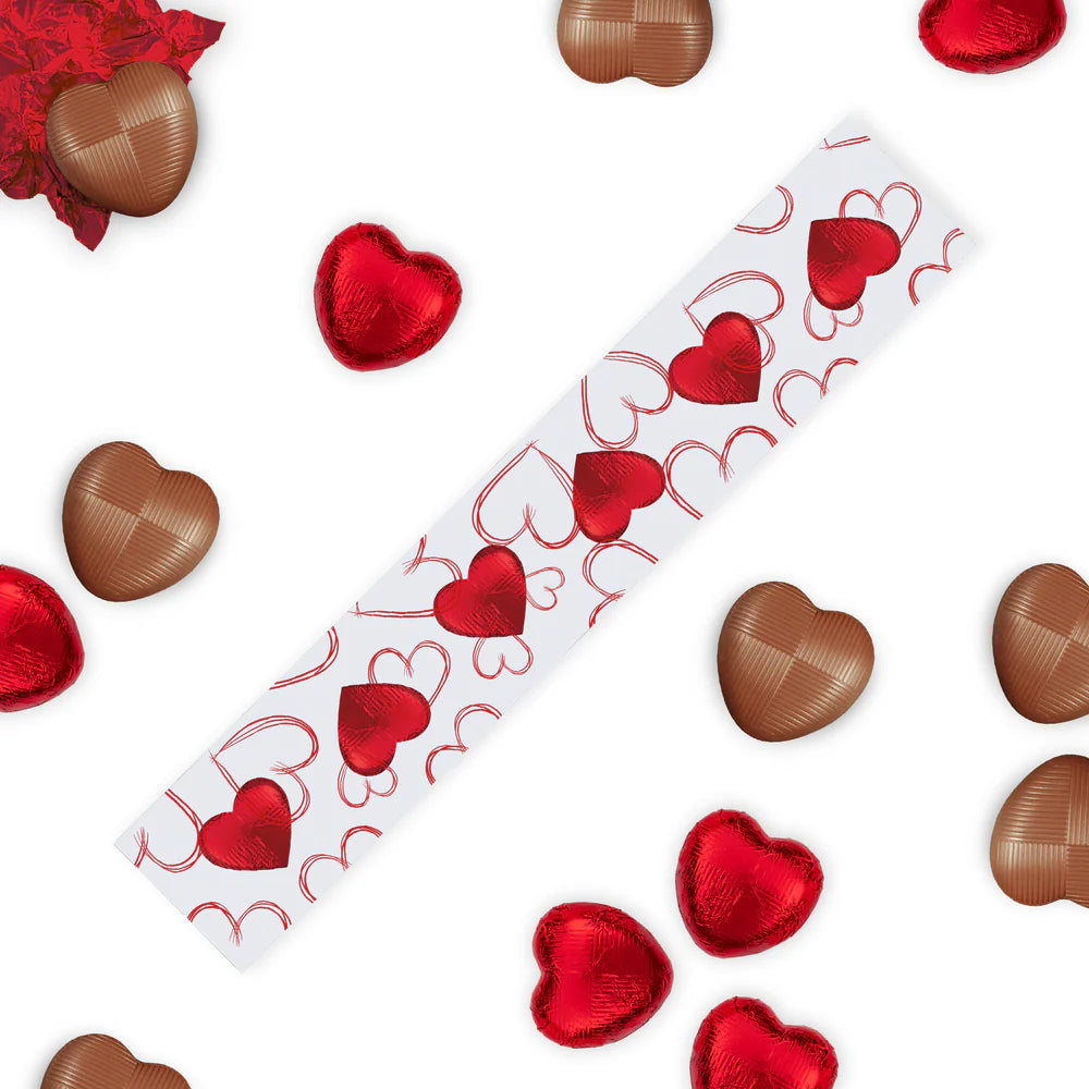 Six red-foiled milk chocolate hearts in romantic packaging