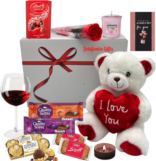 Romantic Valentine gift hamper with assorted chocolates, candles, and plush teddy