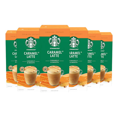 A freshly made Starbucks Caramel Latte from an instant sachet, topped with rich, creamy foam in a white mug