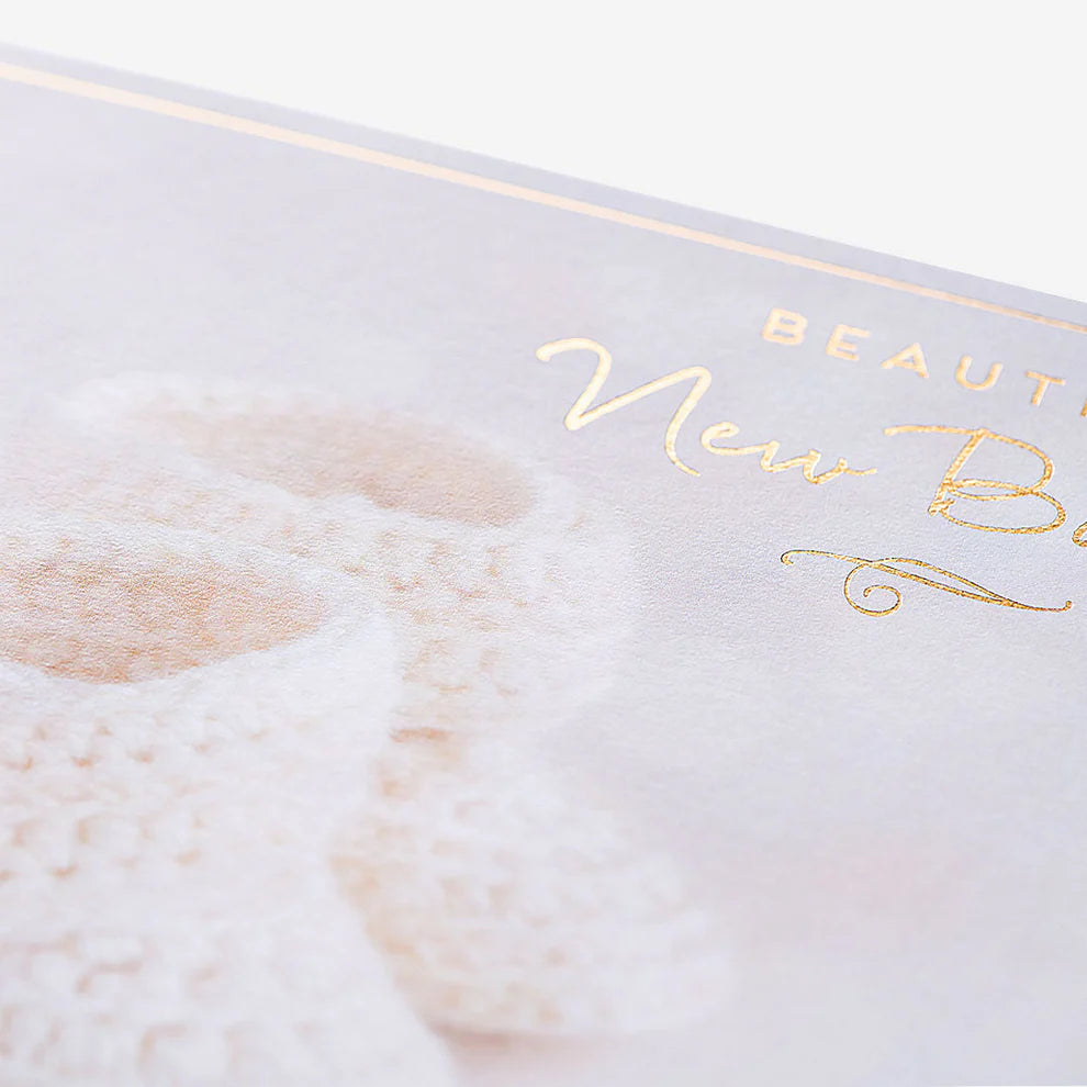 Thoughtful greeting card perfect for new baby gifts, featuring charming baby booties illustration and warm congratulations message.