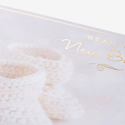 Thoughtful greeting card perfect for new baby gifts, featuring charming baby booties illustration and warm congratulations message.