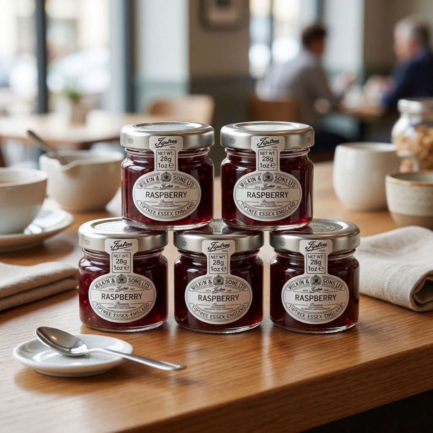 Individual glass jars of raspberry conserve for hotels and cafes