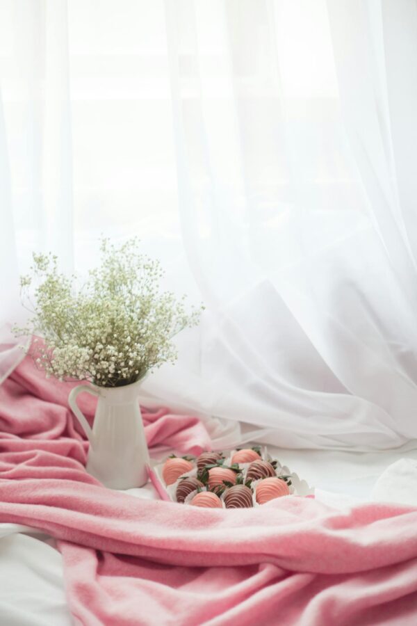 A Box of Strawberry Flavored Chocolates and a Vase of Baby's Breath Flower