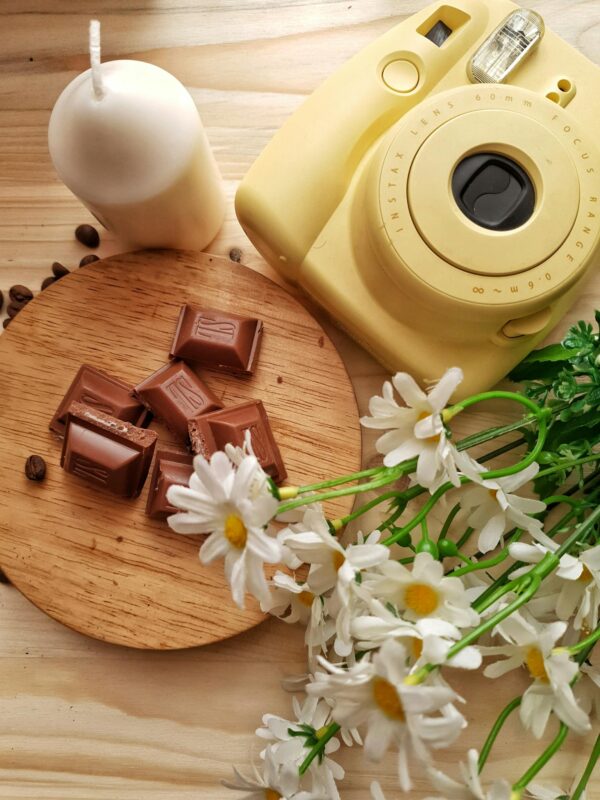 Chocolate with flowers and instant camera