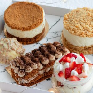 Set of various delicious desserts served in plastic container